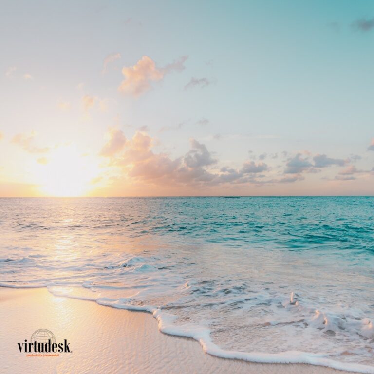 A serene beach at sunset, with vibrant colors reflecting on the water.